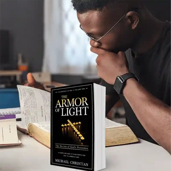 Man studying the Bible with The Armor of Light book